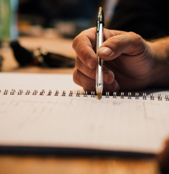 a hand holding a pen